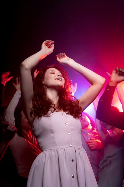 Vida nocturna con gente bailando en un club.