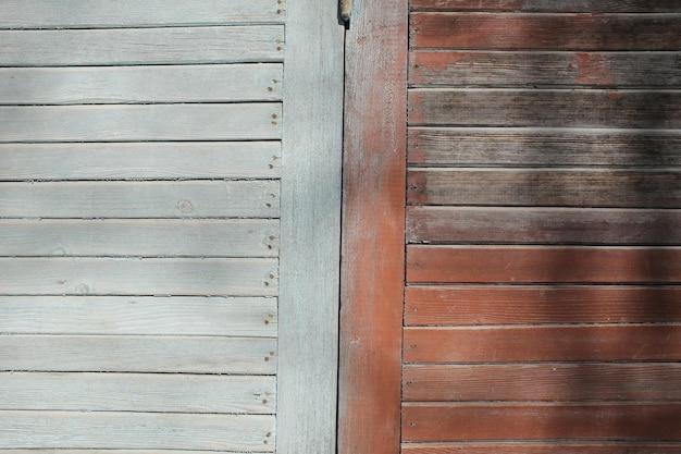 Vieja pared de madera de colores en mal estado en pantalla completa fotografiada a corta distancia