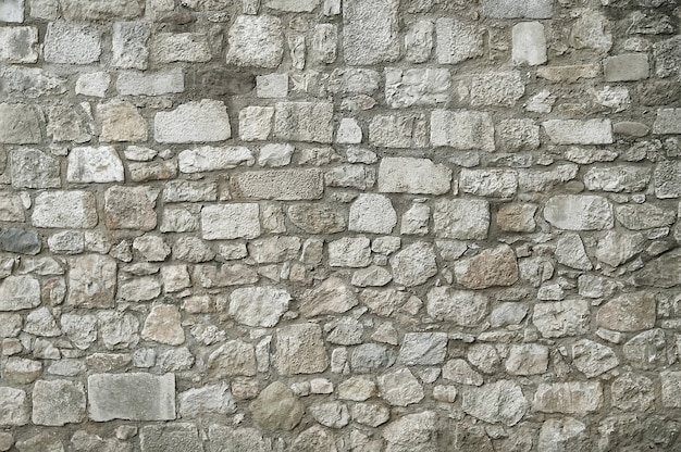 Viejo fondo de la textura de la pared de piedra del granito