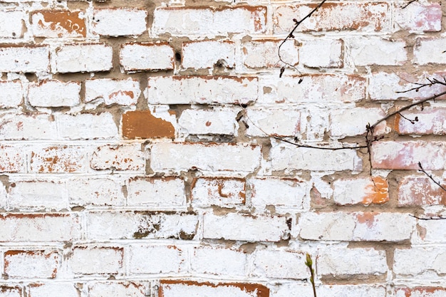Viejo muro de ladrillo con pintura blanca resistida alta textura detallada foto de fondo