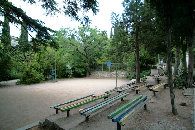 Viejos bancos de colores en el patio de juegos de baloncesto en el parque