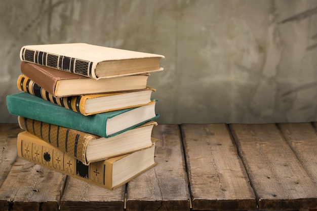 Viejos libros apilados en la mesa de madera