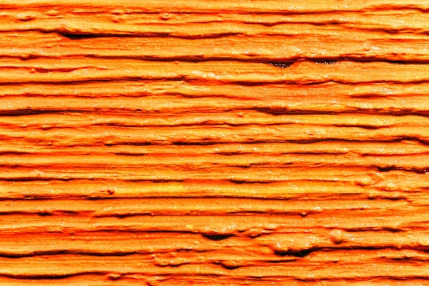 Viele parallele dicke Striche orangefarbener Farbe auf Leinwand Abstrakte Textur mit Linienstruktur