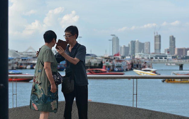 Viele Touristen gehen und machen Fotos an der Brücke Pattaya PierxAufgenommen in Pattaya, Thailand