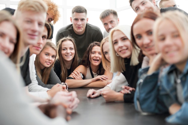 Foto viele verschiedene junge leute sitzen an einem tisch