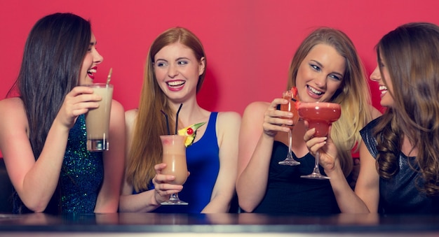 Vier Freunde, die eine Party halten Cocktails haben