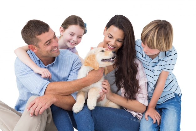 Vierköpfige Familie, die mit Hund spielt