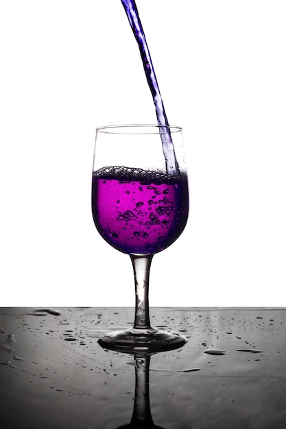 Vierta el agua violeta en una copa de vino.