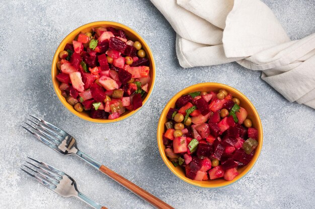 Foto vinagreta de remolacha y verduras hervidas, ensalada tradicional rusa casera. sirviendo cuencos con un refrigerio frío en la mesa, copie el espacio.