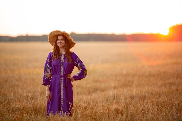 Vinnytsia Ukraine 15. Juli 2022 EIN Mädchen in einem Strohhut bei Sonnenuntergang in einem Kleid