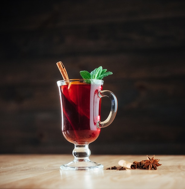 Vino caliente con una rodaja de especias de naranja.