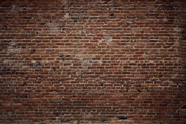 Foto vintage backsteinmauer, tolles design für jeden zweck. hintergrundtextur alt. grunge städtische kulisse. gebrochene oberflächen-grunge-textur. rote backsteinmauer. schmutzige alte oberfläche.