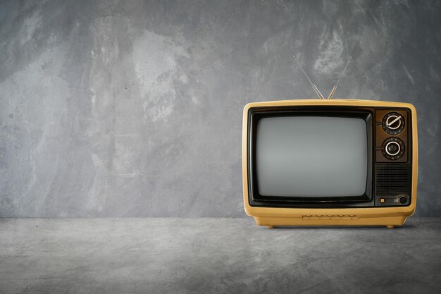 Vintage-Fernseher auf dem Tisch an der Wand