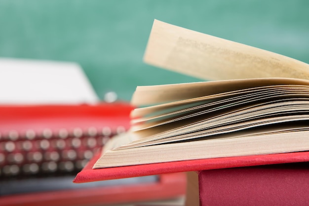 Vintage Schreibmaschine und Buch hautnah auf dem Tisch schreiben oder Journalismus-Konzept