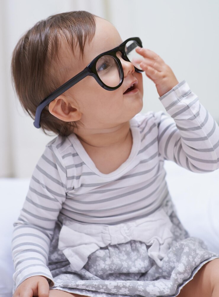 Foto visão e cuidados com os olhos de bebê usando óculos para lentes de prescrição de problemas de visão ou armação de suporte ocular. acessório facial de oftalmologia pediátrica e menina relaxada, criança ou bebê com óculos.