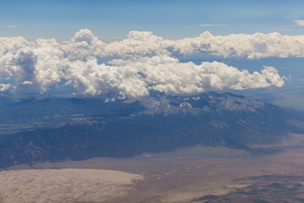 Visão geral no avião de nuvens fofas na paisagem cênica da montanha do Arizona com a cordilheira dos EUA