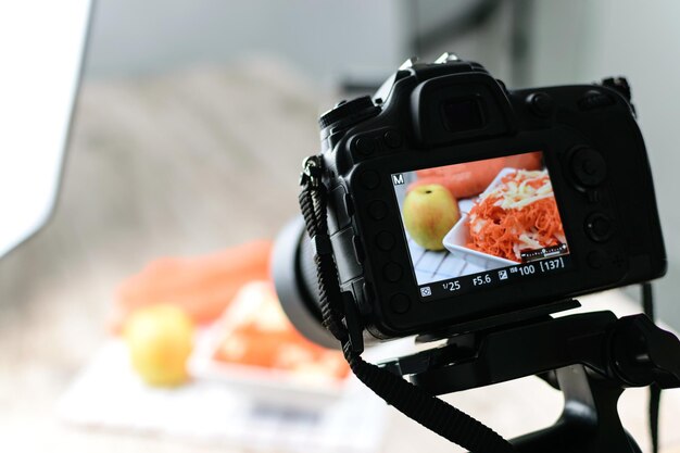 Visão traseira da imagem conceitual da câmera DSLR fazendo uma fotografia de comida no estúdio fotográfico
