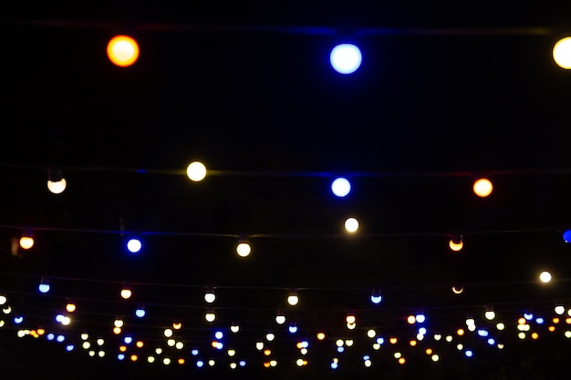 Foto una vista desde abajo de muchas bombillas pequeñas una guirnalda festiva que ilumina el cielo nocturno