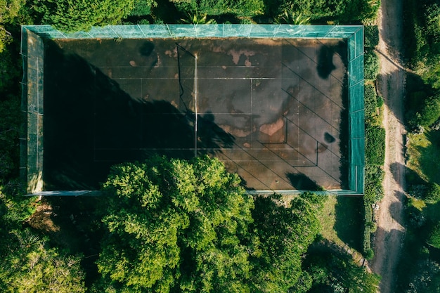 Vista aérea de arriba hacia abajo de la pista de tierra batida de tenis húmedo