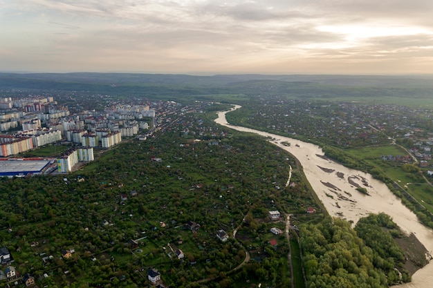 Vista aérea de la ciudad de Ivano-Frankivsk con zona residencial y casas suburbanas con un río en el medio.