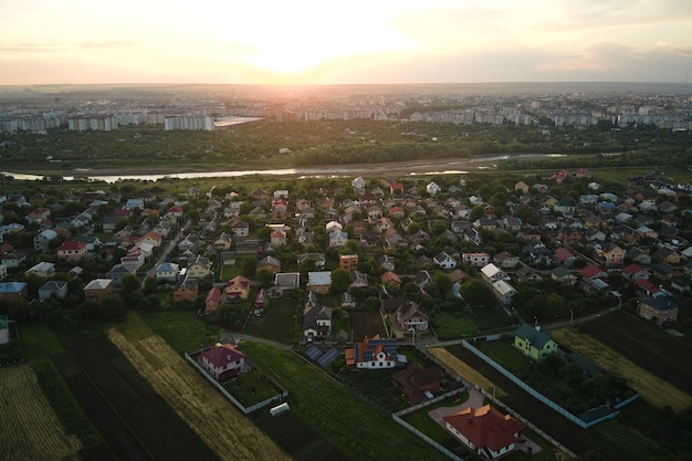 Vista aérea de casas residenciais em áreas rurais suburbanas ao pôr-do-sol