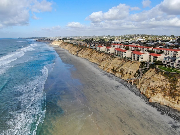 Vista aérea de Del Mar North Beach, falésias costeiras da Califórnia e casa com oceano Pacífico azul