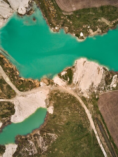 Foto vista aérea de drone paisagem industrial incrível em emerald lake em uma pedreira inundada mina a céu aberto lago oval em cratera industrial drenagem de mina ácida mina a céu aberto com lago