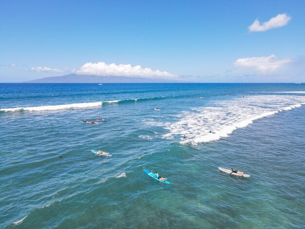 Vista aérea de surfistas e ondas no oceano azul cristalino em Maui Hawaii EUA