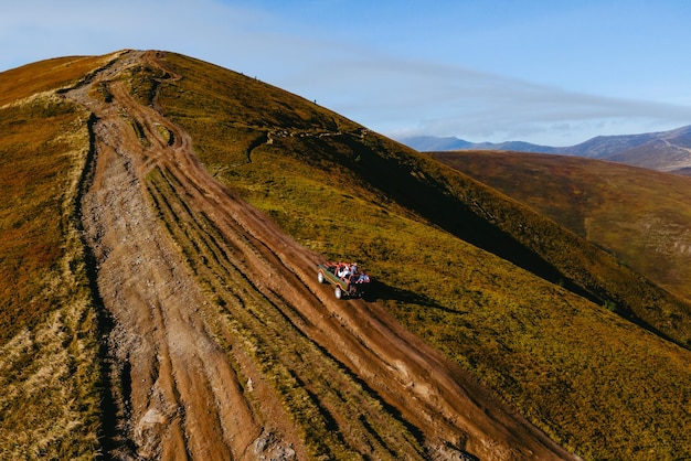 Vista aérea do suv off road travel subindo pela colina da montanha