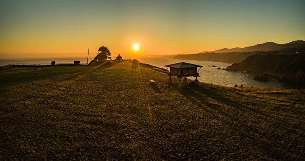 vista aérea de la ermita de la Regalina al atardecer junto a su Hórreo Asturiano