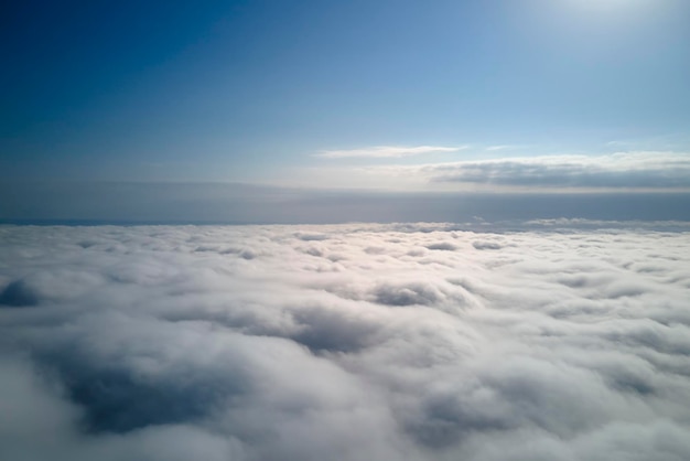 Vista aérea desde una gran altitud de la tierra cubierta con hinchadas nubes lluviosas que se forman antes de la tormenta