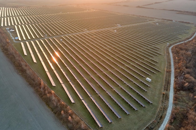 Vista aérea de una gran planta de energía eléctrica sostenible con filas de paneles solares fotovoltaicos para producir energía eléctrica limpia por la noche Concepto de electricidad renovable con cero emisiones