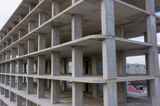 Vista aérea del marco de hormigón del edificio de apartamentos alto en construcción en una ciudad.