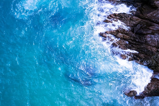 Vista aérea de las olas rompiendo en el mar Olas de espuma blanca en las rocas de la costa Vista superior Vista del paisaje de la montaña de la costa rocosa Fondo de la naturaleza