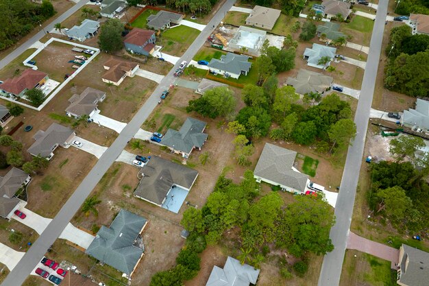 Vista aérea del paisaje de casas privadas suburbanas entre palmeras verdes en la zona rural de Florida