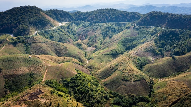 Vista aérea del paisaje del valle de la montaña y sobre el fondo abstracto de la carretera desde la cámara del drone