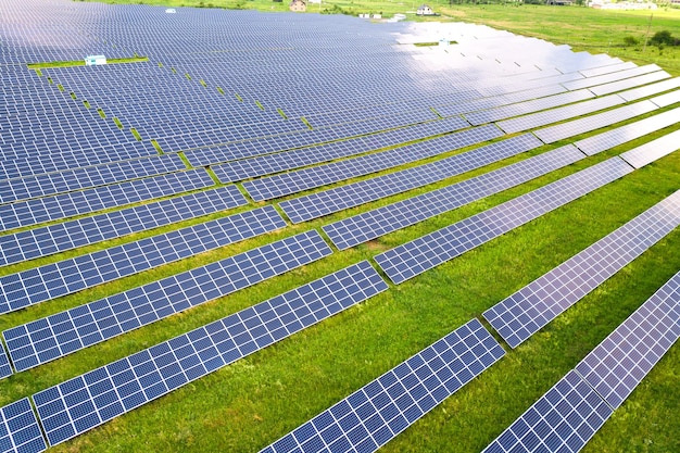 Vista aérea de la planta de energía solar en campo verde. Cuadros eléctricos para producción de energía ecológica limpia.