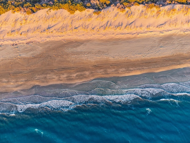 Una vista aérea revela una impresionante playa paradisíaca que invita a los espectadores a disfrutar de una escapada de vacaciones de ensueño.