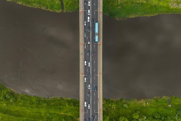 Vista aérea del tráfico pesado en un puente con una amplia carretera de varios carriles a través de un amplio río