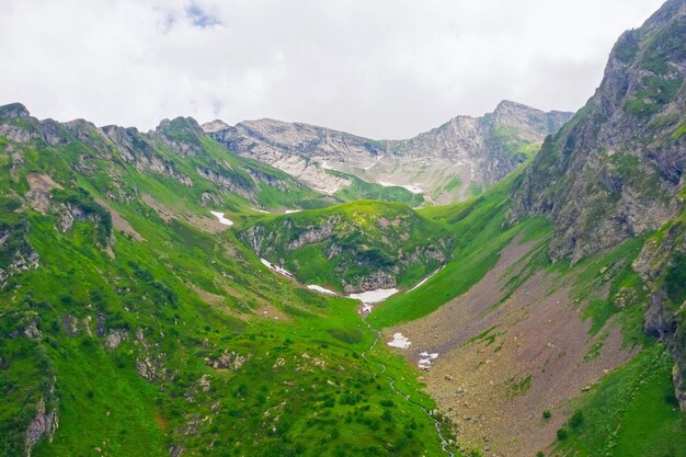 Foto vista aérea de un valle de montaña con prados alpinos y arroyos