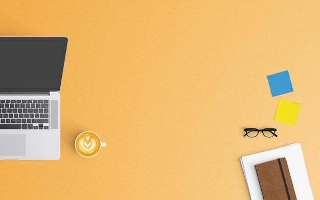 Vista de ángulo alto de la computadora portátil con café y gafas en fondo naranja