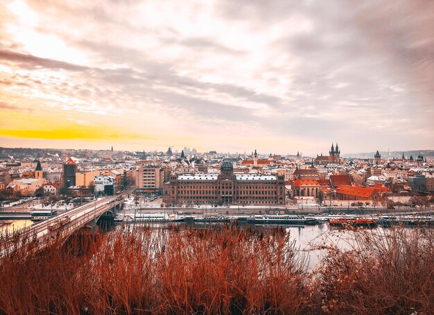 Foto vista en ángulo alto de los edificios por el río contra el cielo durante la puesta de sol