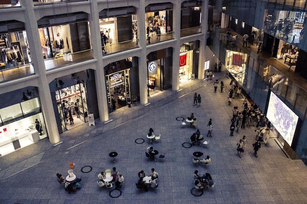 Vista de ángulo alto de la gente en la cafetería de la acera contra el centro comercial