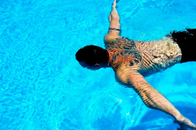 Vista de ángulo alto de un hombre nadando en la piscina