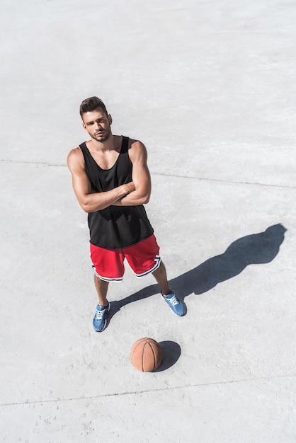 Vista de ángulo alto del jugador de baloncesto atlético de pie en la cancha