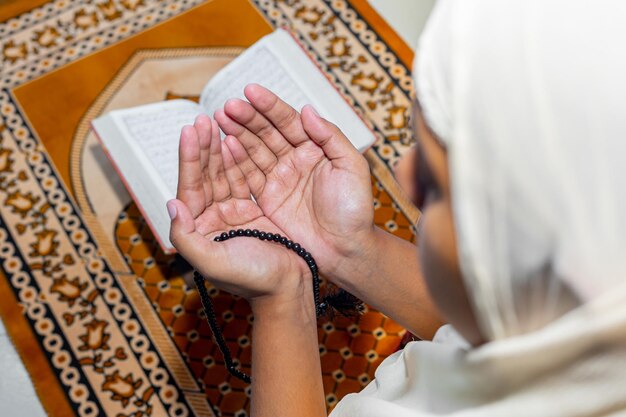 Foto vista de ángulo alto de la mano de la mujer sosteniendo la cruz