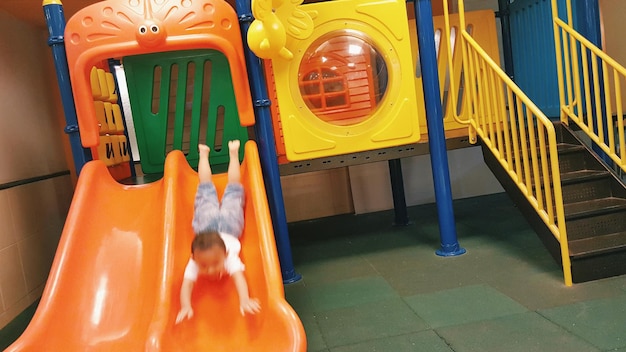 Vista de ángulo alto de un niño jugando en una diapositiva