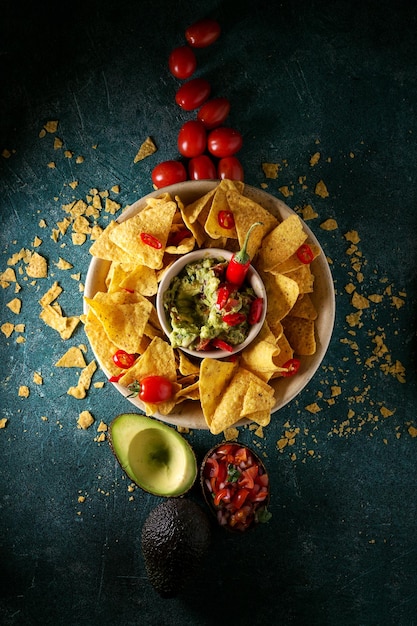 Vista de ángulo alto de las papas fritas de nachos con salsa en la mesa