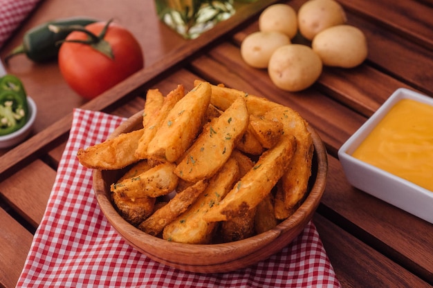 Vista de ángulo alto de patatas fritas en un cuenco en una mesa de madera