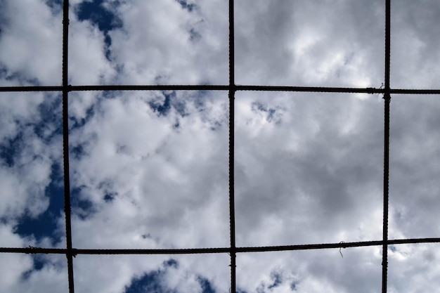 Foto vista de ángulo bajo del cielo a través de alambre metálico con espacio de copia